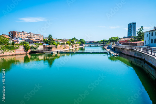 A view from the Roman Tiberius Bridge along the estuary out to sea at Rimini, Italy in summertime