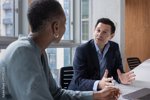 Businessman sharing an idea in a corporate office meeting room photo