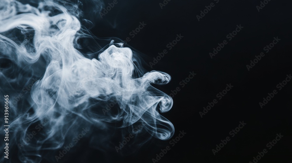 Fototapeta premium Abstract white smoke swirls against a dark background.