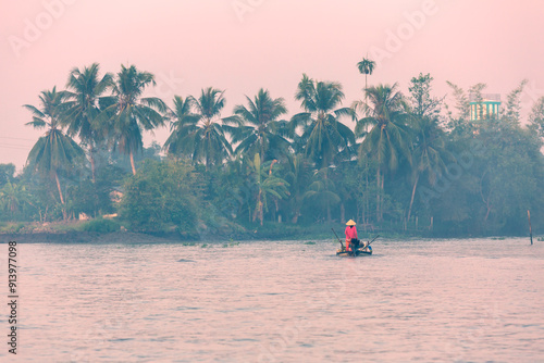 Vietnamese woman on small boat, Mekong Delta, Can Tho, Vietnam photo