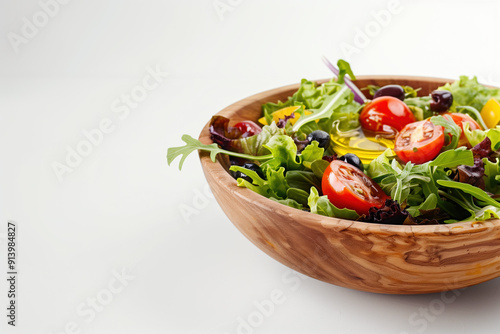 Golden Olive Oil on Vibrant Salad in Rustic Wooden Bowl on White Surface - Natural and Wholesome Meal