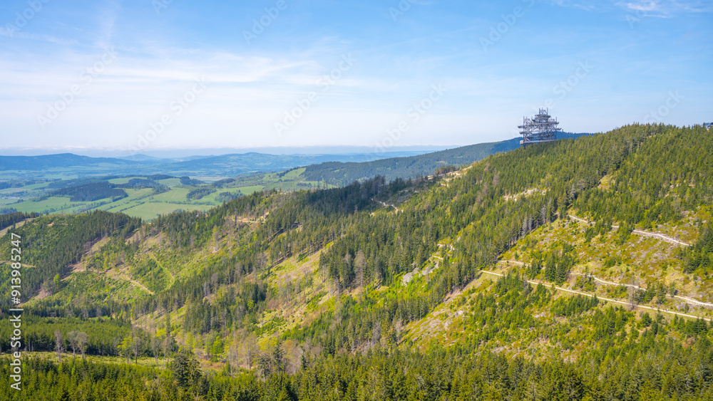 Fototapeta premium A panoramic view of the forested landscape surrounding the Sky Walk lookout tower, located in the Dolni Morava Resort in Czechia.