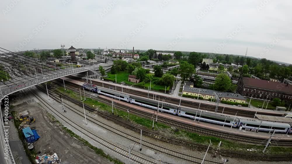 The video shows a train station, a bus station and a bridge over the Oder River in Opole, Poland. The train station is located in the city center and is a major transportation hub for the city . The The video shows a train station, a bus station and a bridge over the Oder River in Opole, Poland. The train station is located in the city center and is a major transportation hub for the city . The