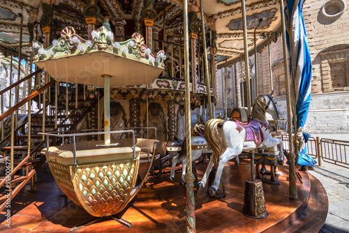 Close up of a merry go round. Although modern carousels are primarily composed of horses, counterparts from earlier periods often included various varieties of animals, such as dogs, horses, rabbits.