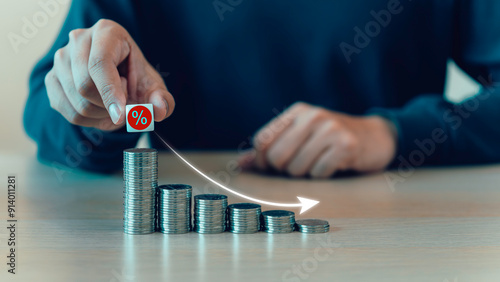 Obraz na płótnie Percent sign moving down from top on coin stack. Central banking system cut interest rate, rising or lowering Fed interest rates to correct inflation concepts. w salonie