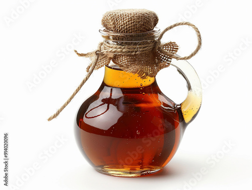 Artisan Maple Syrup in a Glass Jar With Rustic Twine Decoration and Natural Light Background photo