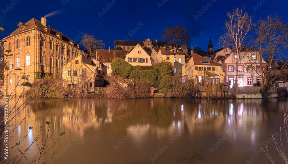 Fototapeta premium Illuminated night view of Bamberg Old Town with reflections on the Regnitz River in Bamberg, Germany