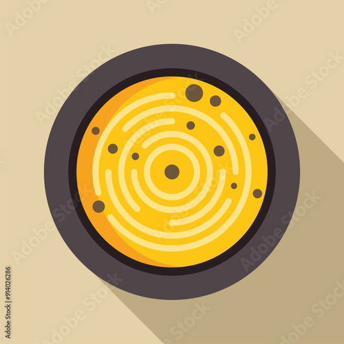 Round yellow food being served in a bowl, with a swirling pattern and black dots, top view