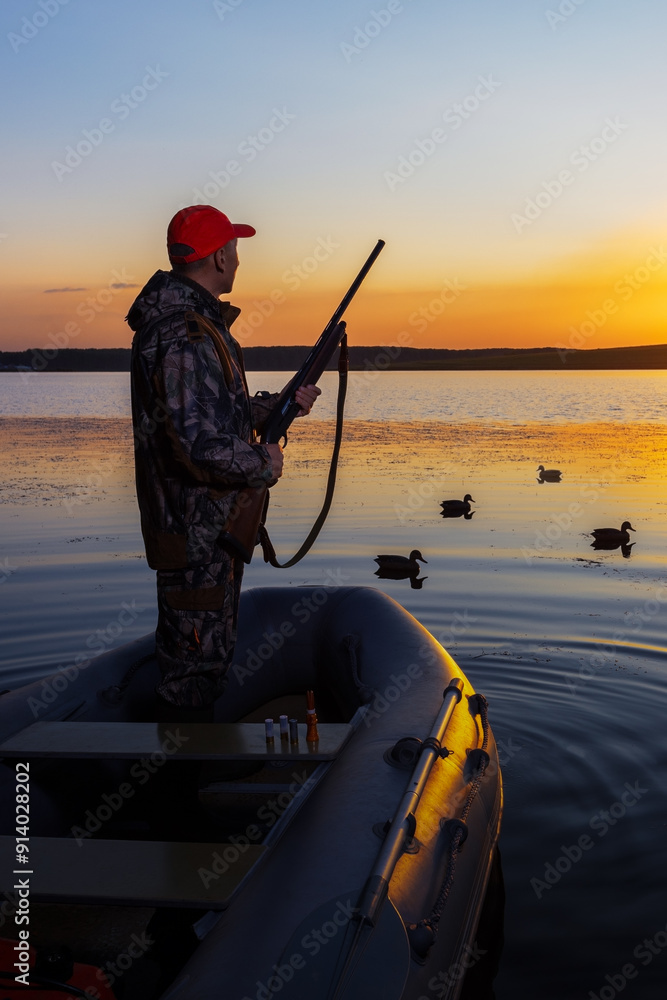 Waterfowl hunter watches the ducks. Man hunting at lake. Waterfowl hunter watches the ducks. Man hunting at lake.