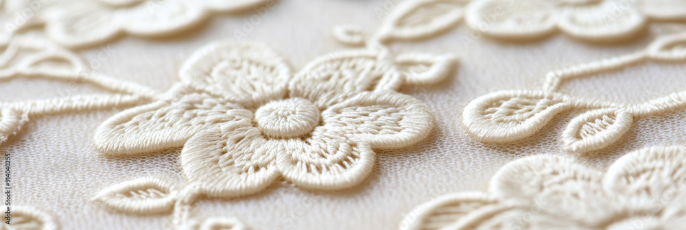 Obraz premium Close-up of delicate ivory lace embroidery with floral patterns, ideal for wedding dress designs and bridal fashion concepts