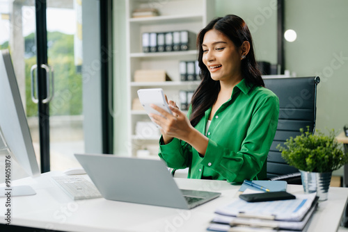 Young attractive Asian female office worker business suits smiling in office .