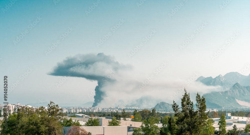 Cloud of smoke in the sky above the city. Mushroom cloud of smoke in the sky after a fire. Cloud of smoke in the sky above the city. Mushroom cloud of smoke in the sky after a fire.