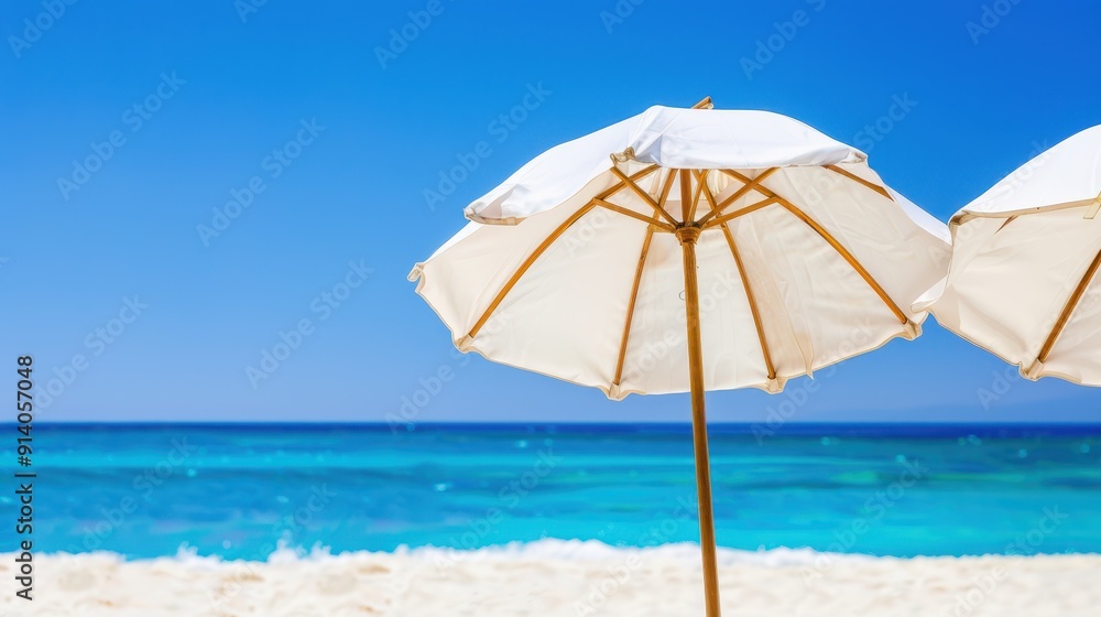 Four white beach umbrellas on a pristine sandy beach with turquoise water and a clear blue sky. Idyllic tropical vacation concept. Four white beach umbrellas on a pristine sandy beach with turquoise water and a clear blue sky. Idyllic tropical vacation concept.