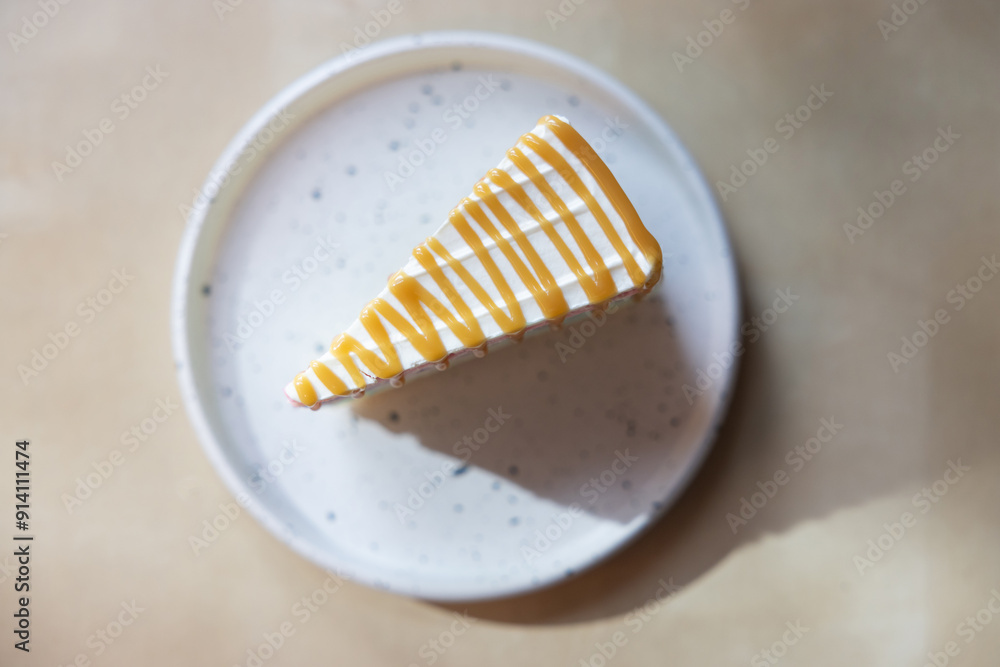 A slice of cake with a caramel drizzle on top sits on a white plate A slice of cake with a caramel drizzle on top sits on a white plate