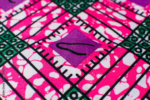 top view of pink ankara fabric, flatlay of nigerian wax cloth with designs, spread out pink ankara material photo