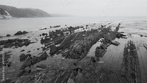 Rock textures at low tide at the Sakoneta Flysch and Punta Mendata on the Cantabrian Coast in Deva. Aerial view from a drone. Cantabrian Sea. Gipuzkoa Province. Basque Country. Spain. Europe photo