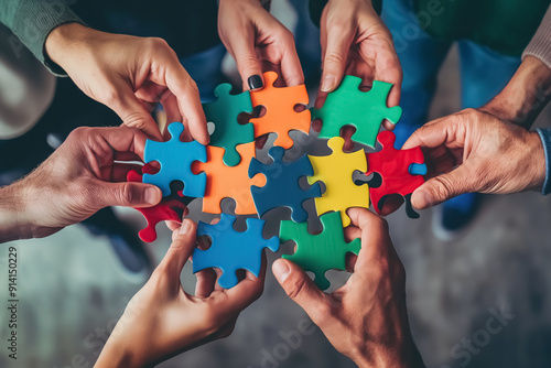 A group of diverse hands holding colorful puzzle pieces that fit together perfectly, symbolizing the idea that each person's unique qualities can contribute to an overall whole or team success