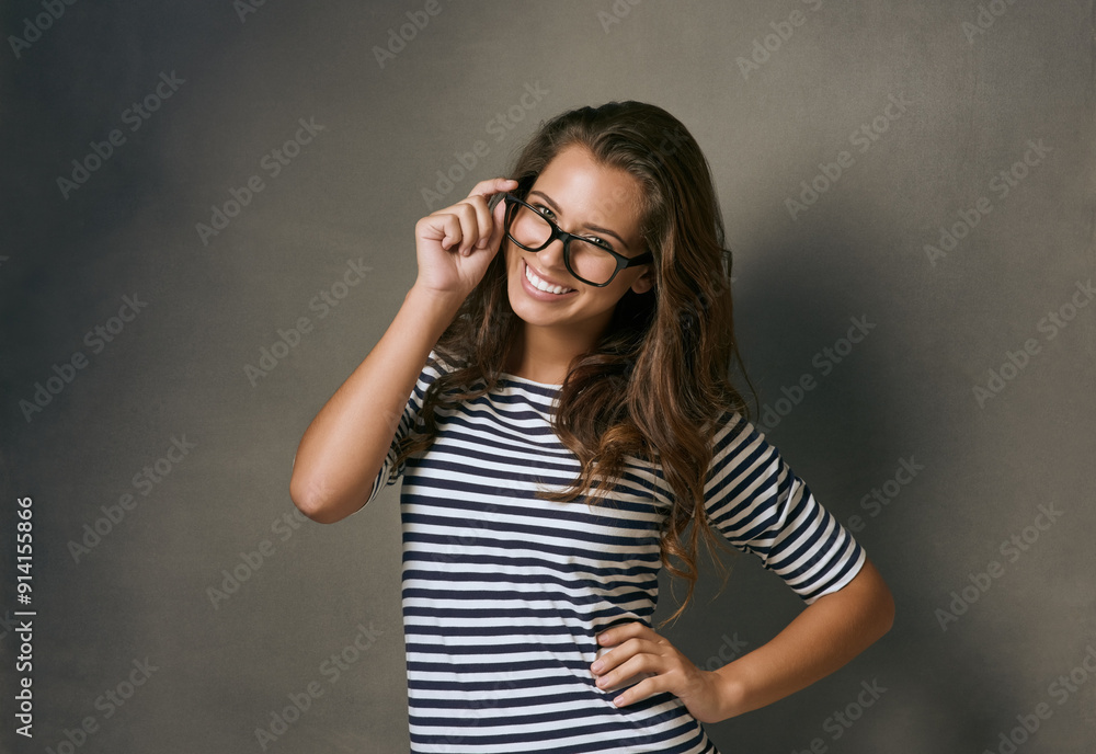 Woman, portrait and smile with glasses in studio with prescription lens for eye care, optometry and healthcare. IT professional, confident and gray background with spectacles for vision and space. Woman, portrait and smile with glasses in studio with prescription lens for eye care, optometry and healthcare. IT professional, confident and gray background with spectacles for vision and space.