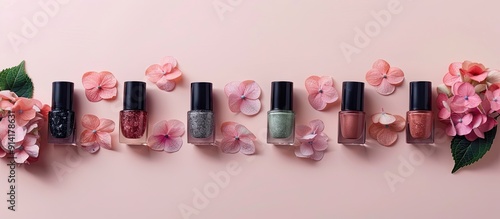 Various nail polish colors displayed on a light background with pink hydrangea flowers in a flat lay mock up depicting decorative cosmetics in a beauty blogger concept with copy space image photo