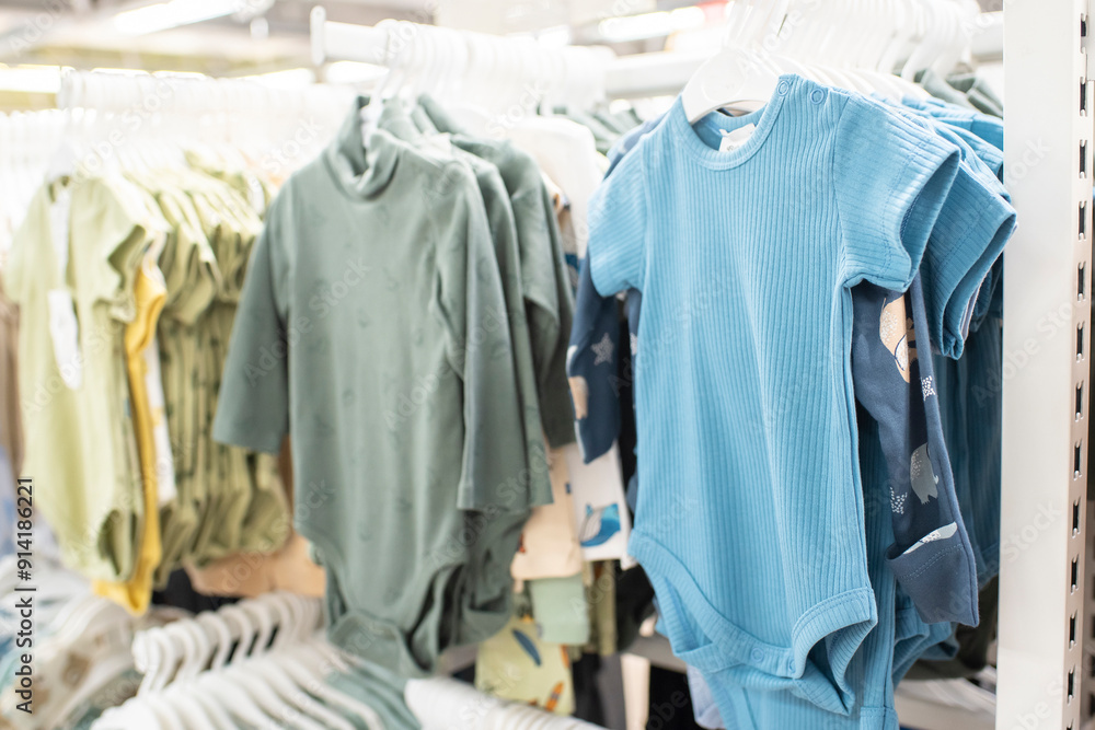 baby clothes on hangers in a store baby clothes on hangers in a store