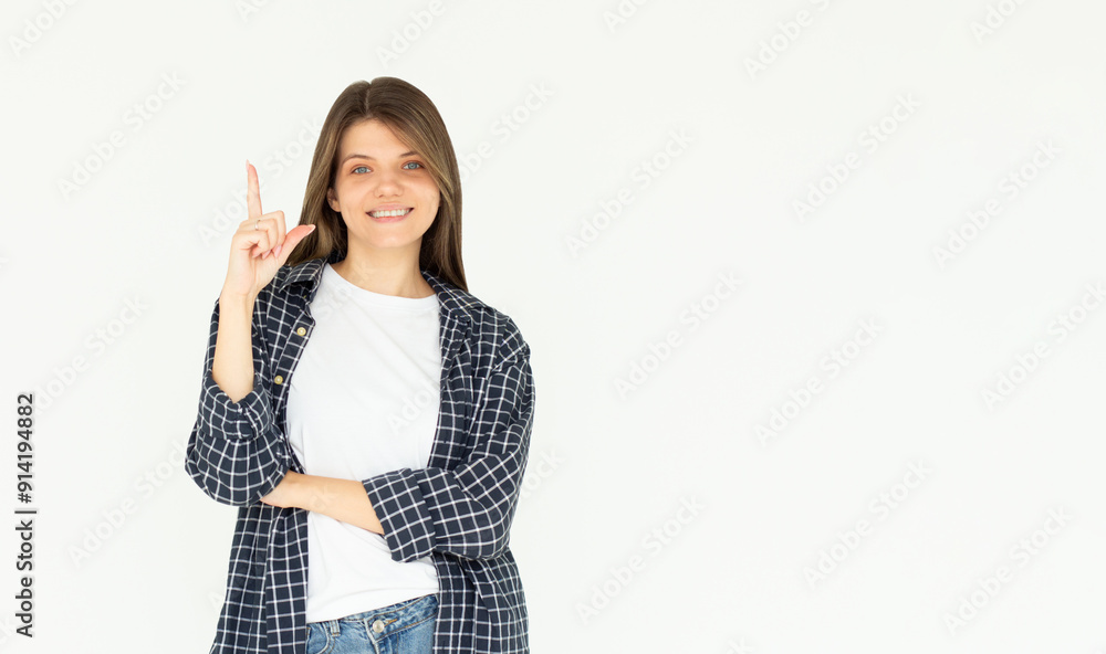 Smiling woman pointing finger up over white background Smiling woman pointing finger up over white background