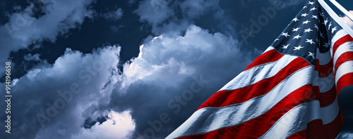 American flag fluttering in the wind. Clouds before a thunderstorm and storm