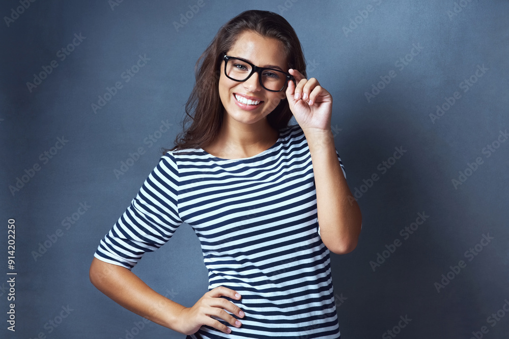 Girl, portrait and confidence with glasses in studio with prescription lens for eye care, optometry and healthcare. IT professional, happy and blue background with spectacles for vision and eyesight. Girl, portrait and confidence with glasses in studio with prescription lens for eye care, optometry and healthcare. IT professional, happy and blue background with spectacles for vision and eyesight.
