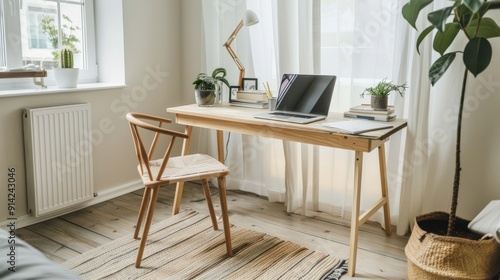 A minimalist home office with a wooden desk, chair, and laptop. Plants and a lamp provide a touch of life and warmth.