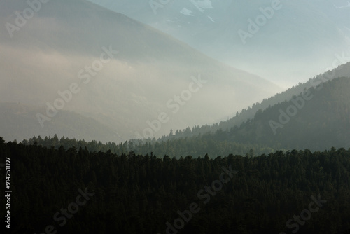 The evening fog creates depth within the mountains, in Rocky Mountain National Park, Colorado in early August photo