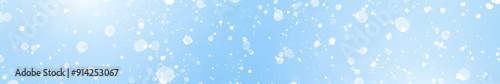  White Bokeh Light Effects on Blue winter Background. Long banner