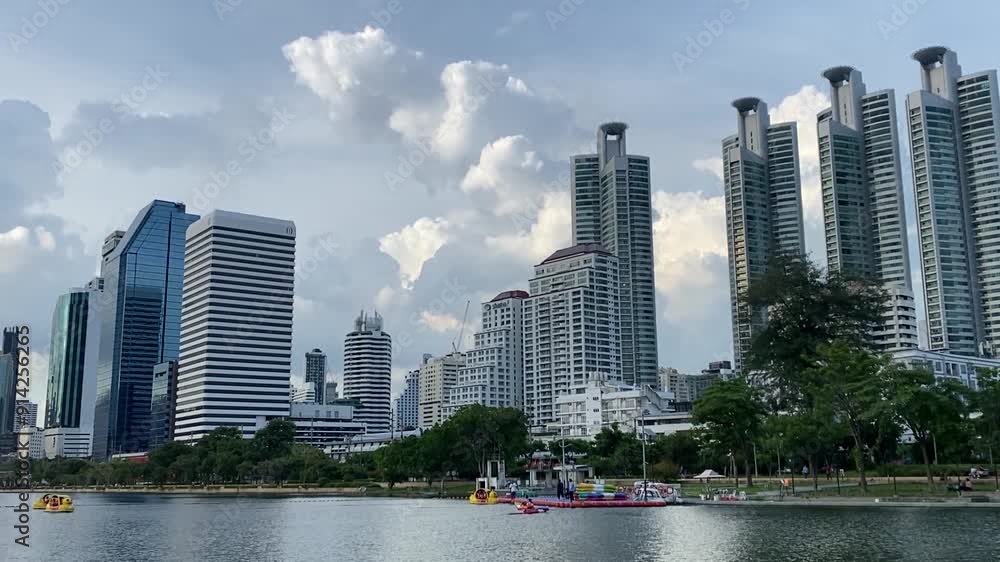 Tall buildings in Bangkok's business district and lake view of Benjakitti Park