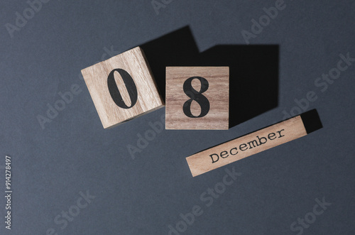 Wooden calendar with the date december 08 on a dark background. Top view photo