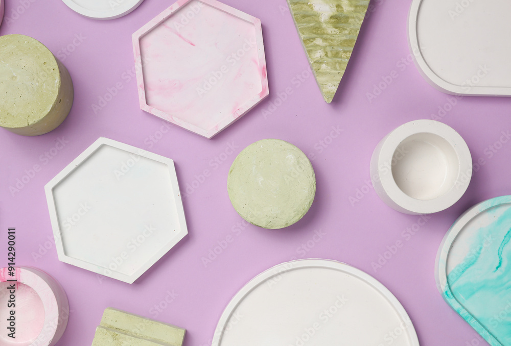 Set of Decorative pink plaster trays of different shapes on purple background with shadows. Stands for candles, organizers for cosmetics or jewelry. Top view Set of Decorative pink plaster trays of different shapes on purple background with shadows. Stands for candles, organizers for cosmetics or jewelry. Top view