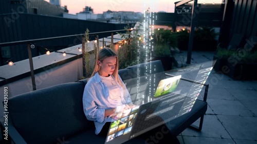 A Young Beautiful Blonde Woman is Working on their Laptop with Holographic Projections Outside. Visualization of the Internet by Information Lines Flying to the Global Digital Network