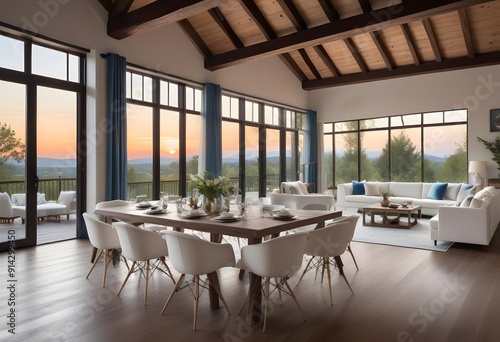 A modern dining room with high ceilings, wooden beams, and large arched windows overlooking a scenic outdoor view. The room features a wooden dining table surrounded by teal upholstered chairs, 