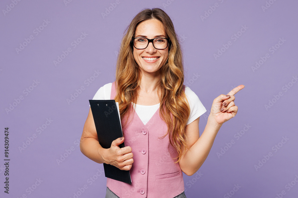 Young employee business woman corporate lawyer wear suit vest white t-shirt glasses work in office hold clipboard with paper account documents point finger aside isolated on plain purple background. Young employee business woman corporate lawyer wear suit vest white t-shirt glasses work in office hold clipboard with paper account documents point finger aside isolated on plain purple background.