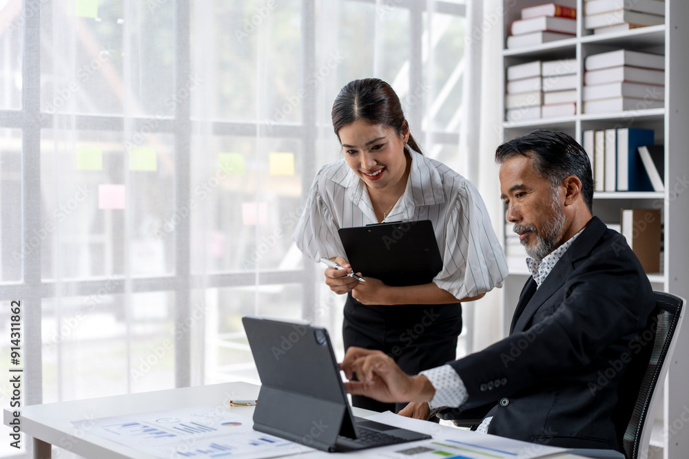 A woman and a man are working together on a laptop A woman and a man are working together on a laptop