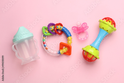 Toys and accessories for a newborn on a pink background