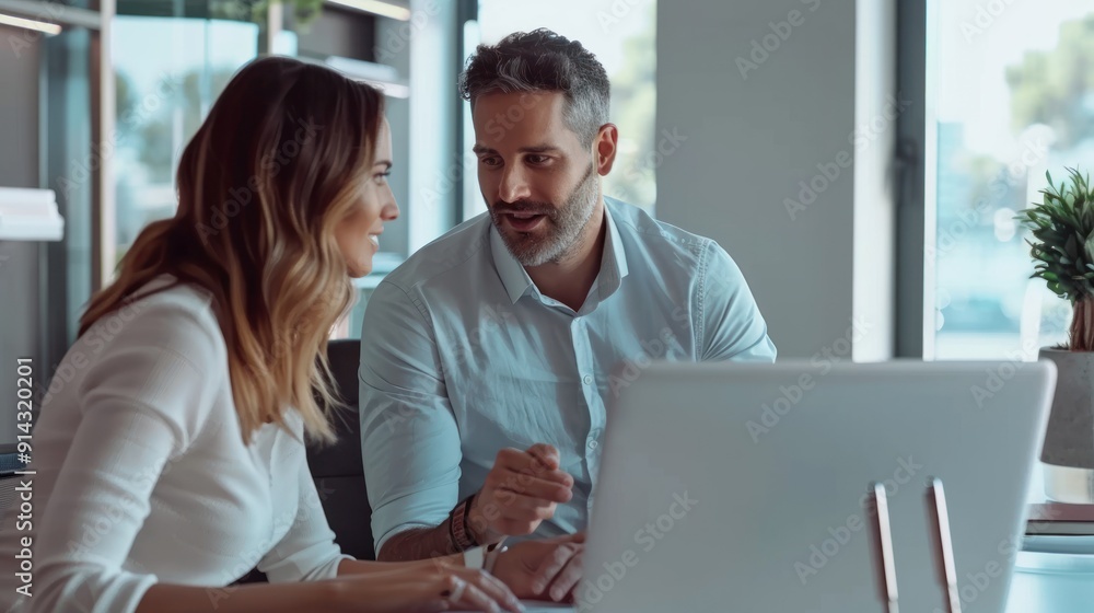 Loan officer explaining loan options to a couple in an office. Loan officer explaining loan options to a couple in an office.