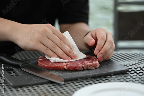 Photos Drying Steak for a Perfect Cook, Hands gently patting down a raw steak to dry of