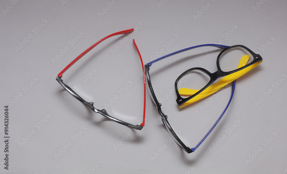 Stylish fashion eyeglasses on gray background. Top view Stylish fashion eyeglasses on gray background. Top view