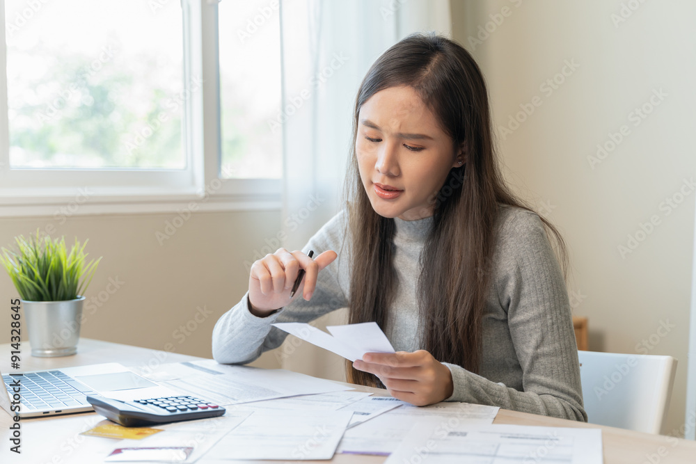 Financial owe, hand of asian woman sitting, holding credit card, stressed by calculate expense from invoice or bill, no money to pay, mortgage or loan Financial owe, hand of asian woman sitting, holding credit card, stressed by calculate expense from invoice or bill, no money to pay, mortgage or loan