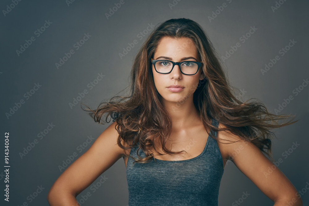 Breeze, hair care and portrait of woman with confidence for beauty, makeup or wind. Hairstyle, face and model in glasses at hairdresser for salon treatment cosmetic isolated on gray studio background Breeze, hair care and portrait of woman with confidence for beauty, makeup or wind. Hairstyle, face and model in glasses at hairdresser for salon treatment cosmetic isolated on gray studio background