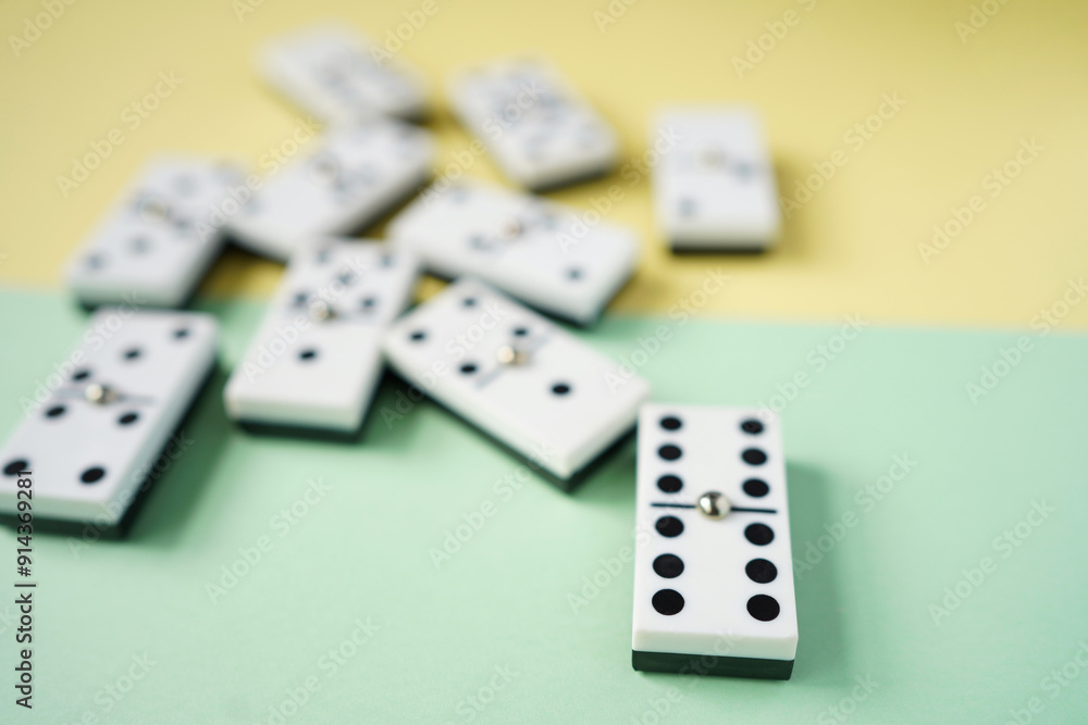 White domino blocks on yellow and green background. High angle shot. White domino blocks on yellow and green background. High angle shot.
