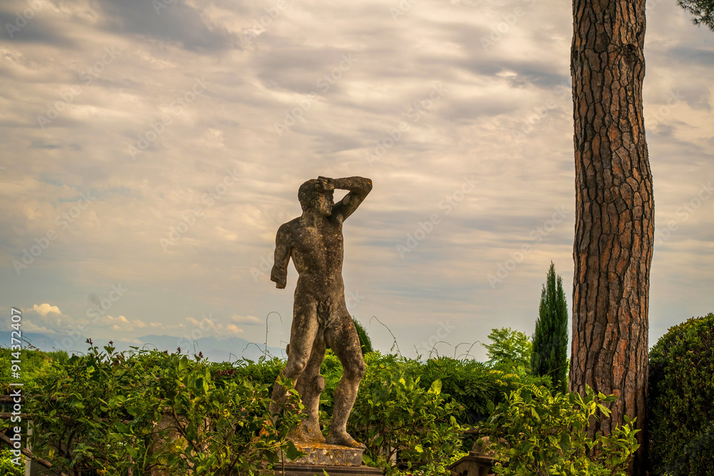 Ancient Stone Statue in Lush Garden with Cloudy Sky, , Gardens of Villa Cimbrone villa in ravello, Italy, Europe