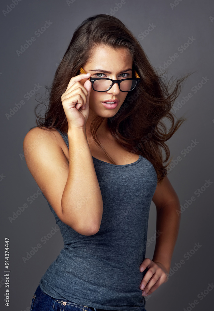 Portrait, glasses and woman with confidence, attitude and optometry on gray studio background. Face, person and model with eyewear, sight and looking with casual outfit, clear vision and wellness Portrait, glasses and woman with confidence, attitude and optometry on gray studio background. Face, person and model with eyewear, sight and looking with casual outfit, clear vision and wellness