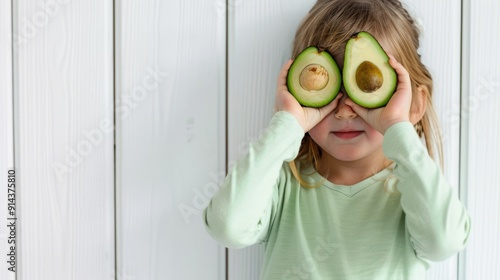 The cute child with avocados photo