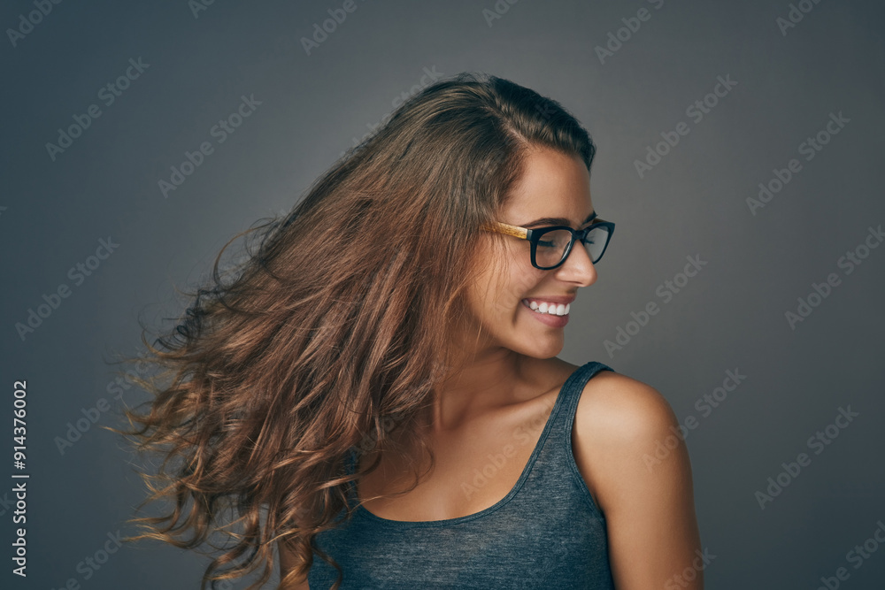 Smile, hair care and woman shake for beauty, texture or growth isolated on gray studio background. Hairstyle, cosmetics and model in glasses at hairdresser for salon treatment, results and natural Smile, hair care and woman shake for beauty, texture or growth isolated on gray studio background. Hairstyle, cosmetics and model in glasses at hairdresser for salon treatment, results and natural