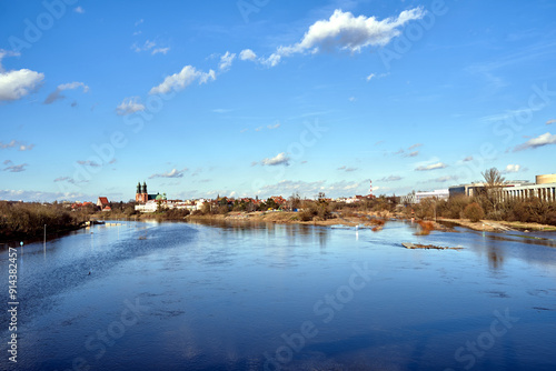 Historic buildings and towers of the gothic cathedral on the Warta River in the city of Poznan photo