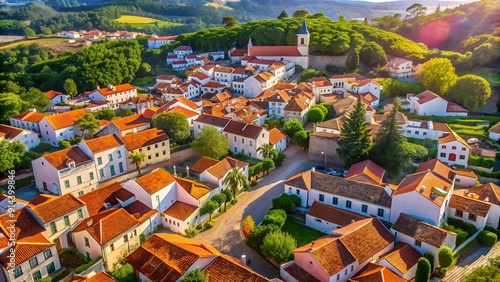 Fototapeta Naklejka Na Ścianę i Meble -  Sun-Kissed Tiles and Winding Streets: A Bird's Eye View of a Portuguese Village  AI generated